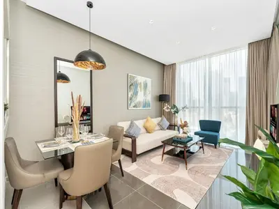 a living room with a table and a couch at NEW Noma Majestine Hotel Style Apt Business Bay in Dubai
