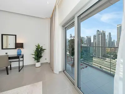 an apartment with a balcony with a view of the city at NEW Noma Majestine Hotel Style Apt Business Bay in Dubai