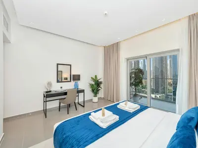 a bedroom with a bed and a desk in a room at NEW Noma Majestine Hotel Style Apt Business Bay in Dubai