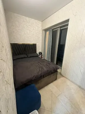 a bedroom with a bed and a blue chair at Marina Sea View Room Dubai in Dubai