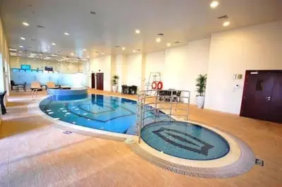 a large room with a swimming pool in a building at Marina Sea View Room Dubai in Dubai