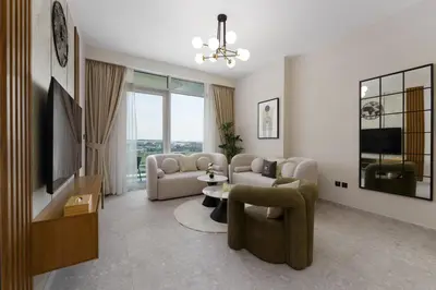 a living room with two couches and a tv at Maison Privee - Tranquil Living with Golf Course Vws in Dubai Hills in Dubai