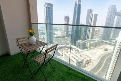 a table and chairs in a room with a view of a city at HAVN - High Floor 2 bedroom in Downtown in Dubai