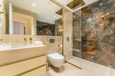 a bathroom with a toilet and a shower and a sink at Elegant 1BR, Easy Access to Creek Harbour Night Vision - Summer at Creek Beach Building 3 by Deluxe Holiday Homes in Dubai