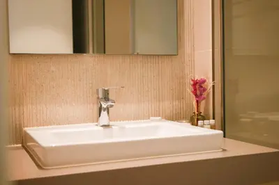 a white sink in a bathroom with a mirror at HAVN - High Floor 2 bedroom in The Grand in Dubai