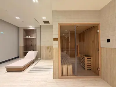 a room with a glass door in a room with a bed at Luxury Apartment with Private Pool & Gym in Dubai