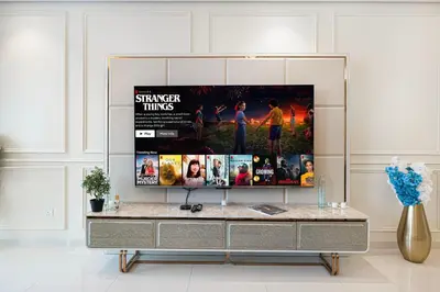 a entertainment center with a movie poster on the wall at Famous Sky Pool at Paramount's King's 2BR in Dubai