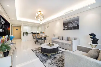 a living room with a couch and a table at Famous Sky Pool at Paramount's King's 2BR in Dubai