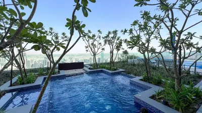 a swimming pool on top of a building with trees at Famous Sky Pool at Paramount's King's 2BR in Dubai
