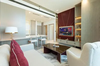 a living room with a couch and a tv at High-Floor Apartment with Balcony Pool in Dubai
