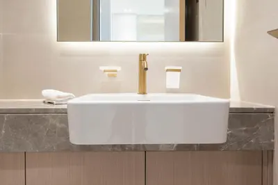 a white sink in a bathroom with a mirror at High-Floor Apartment with Balcony Pool in Dubai
