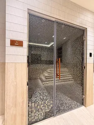 a glass door in a building with stairs behind it at Designer Apartment with Private Pool in Dubai