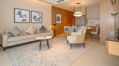 a living room with a couch and a dining room at Prestige 3Bed with Full Iconic Burj Khalifa Views in Dubai