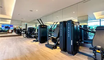 a gym with treadmills and cardio equipment in it at Prestige 3Bed with Full Iconic Burj Khalifa Views in Dubai