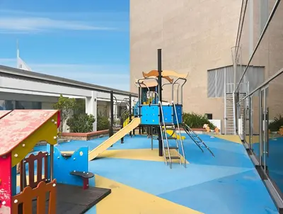 a playground in front of a building with a slide at Luxury High-Floor Suite Museum of the Future View in Dubai