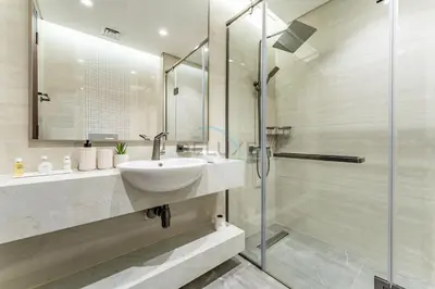 a bathroom with a sink and a shower at High-Floor 2BR with Vibrant Street Views and Effortless Drive Access to Downtown Hotspots, Nobles Tower, Business Bay by Deluxe Holiday Homes in Dubai