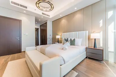a bedroom with a large white bed and a couch at High-Floor 2BR with Vibrant Street Views and Effortless Drive Access to Downtown Hotspots, Nobles Tower, Business Bay by Deluxe Holiday Homes in Dubai