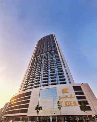 a tall building with a sign on the side of it at High-Floor 2BR with Vibrant Street Views and Effortless Drive Access to Downtown Hotspots, Nobles Tower, Business Bay by Deluxe Holiday Homes in Dubai