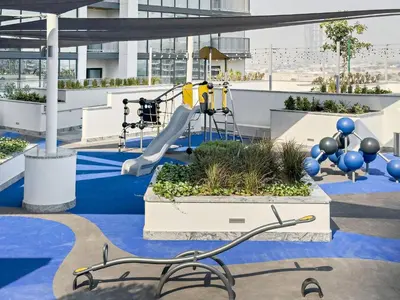 a playground on the roof of a building with a slide at Stylish 1BR Sobha The Crest Pool & City View in Dubai