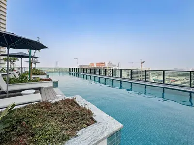 a swimming pool on the top of a building at Stylish 1BR Sobha The Crest Pool & City View in Dubai