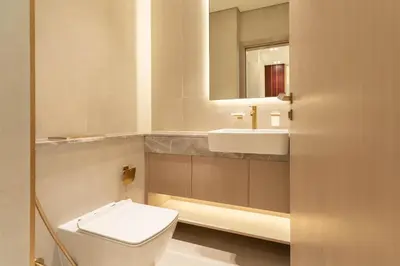 a bathroom with a toilet and a sink and a mirror at Modern Apartment with Private Balcony Pool in Dubai