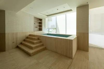 a bathroom with a hot tub and stairs in a room at Luxury Apartment with Private Pool in JVC in Dubai