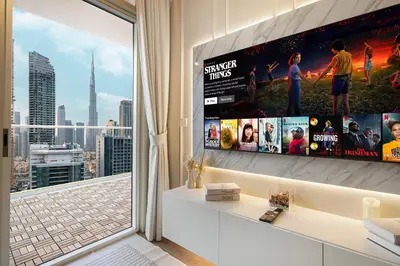 a living room with a large window and a tv at Designer 2BR with Burj View 5 Min to Dubai Mall in Dubai