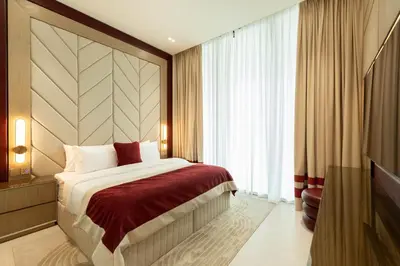 a hotel room with a bed and a large window at Luxury City Apartment with Private Pool in Dubai