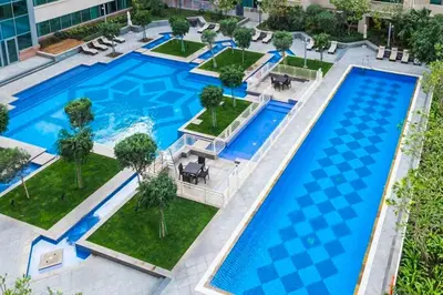 an overhead view of a large pool in a building at Elegant studio balcony boulevard view in Dubai