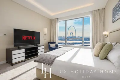 a hotel room with a large bed and a tv at LUX Iconic Views at The Palm Tower Suite 7 in Dubai