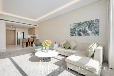 a living room with a couch and a table at LUX Iconic Views at The Palm Tower Suite 7 in Dubai