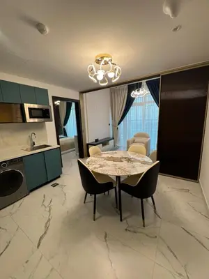 a kitchen and dining room with a table and chairs at Opalz 1 bhk luxury apt for family and couple with swimming pool in Dubai