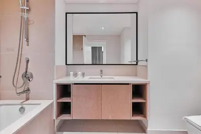 a bathroom with a sink and a tub and a mirror at Premium 2BR Residence in Downtown Dubai in Dubai