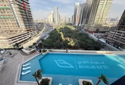 a swimming pool in a city with tall buildings at Refined High-Floor Apartment with Pool in Dubai