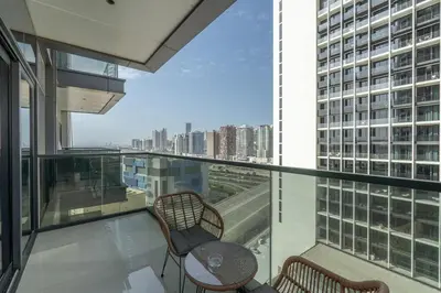 a balcony with a table and chairs on a building at Modern Chic 1BHK Nobles Tower by Czechin in Dubai