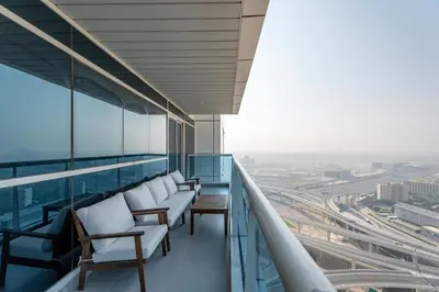 a balcony with chairs and a view of a city at Gala Guests - Classic Opal Tower Suites Dubai Marina in Dubai