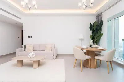 a living room with a couch and a table at Gala Guests - Classic Opal Tower Suites Dubai Marina in Dubai