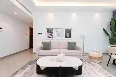 a living room with a couch and a table at Gala Guests - Classic Opal Tower Suites Dubai Marina in Dubai