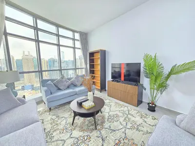 a living room with a couch and a tv at Marina Breeze - Serene Yacht Views near Ain Dubai 3 BR Apartment in Dubai