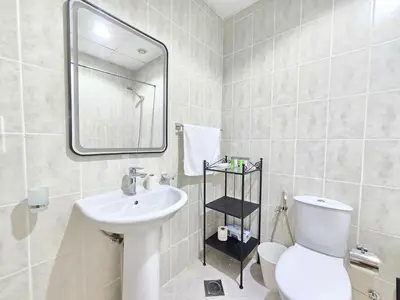 a bathroom with a sink and a toilet and a mirror at Marina Breeze - Serene Yacht Views near Ain Dubai 3 BR Apartment in Dubai