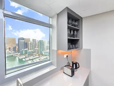 a room with a window with a view of the city at Marina Breeze - Serene Yacht Views near Ain Dubai 3 BR Apartment in Dubai