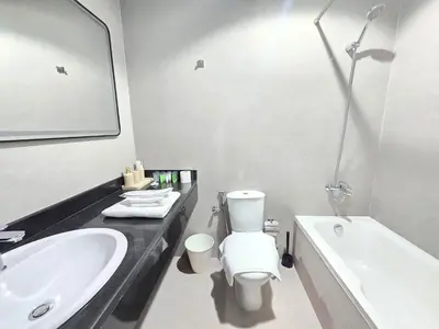 a bathroom with a sink and a toilet and a tub at Marina Breeze - Serene Yacht Views near Ain Dubai 3 BR Apartment in Dubai