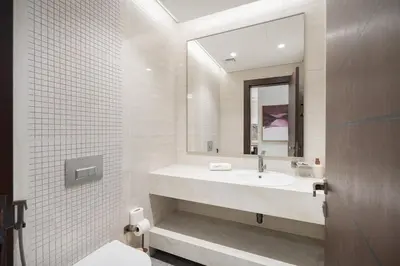 a bathroom with a sink and a mirror at Stylish 1BHK Retreat at Nobles Tower, by Czechin in Dubai