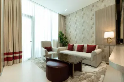 a living room with a couch and a table at Premium Apartment with Private Balcony Pool in Dubai
