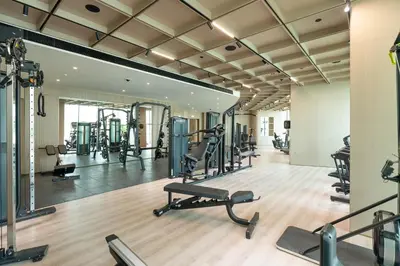a gym with tread machines and a mirror at Premium Apartment with Private Balcony Pool in Dubai