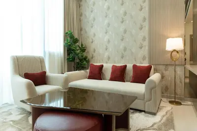 a living room with a couch and a table at Premium Apartment with Private Balcony Pool in Dubai
