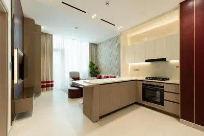 a kitchen with a stove and a counter top at Exclusive Luxury Apartment with Private Pool in Dubai