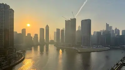 a view of a city with a river and buildings at Stunning Canal View Studio Business Bay in Dubai