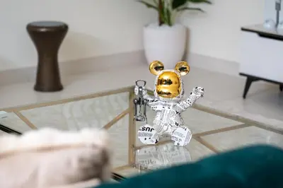 a toy skeleton standing on a glass table at Luxury 3BR in Mada Residences - Walk to Dubai Mall in Dubai