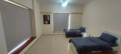 a room with a bed and a chair in it at Festive Winter Stay in JBR - Beach, Marina, Metro in Dubai